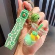 Wholesale Creative Green Fruit in Oil Floating Quicksand Drift Bottle Acrylic Keychain Supply